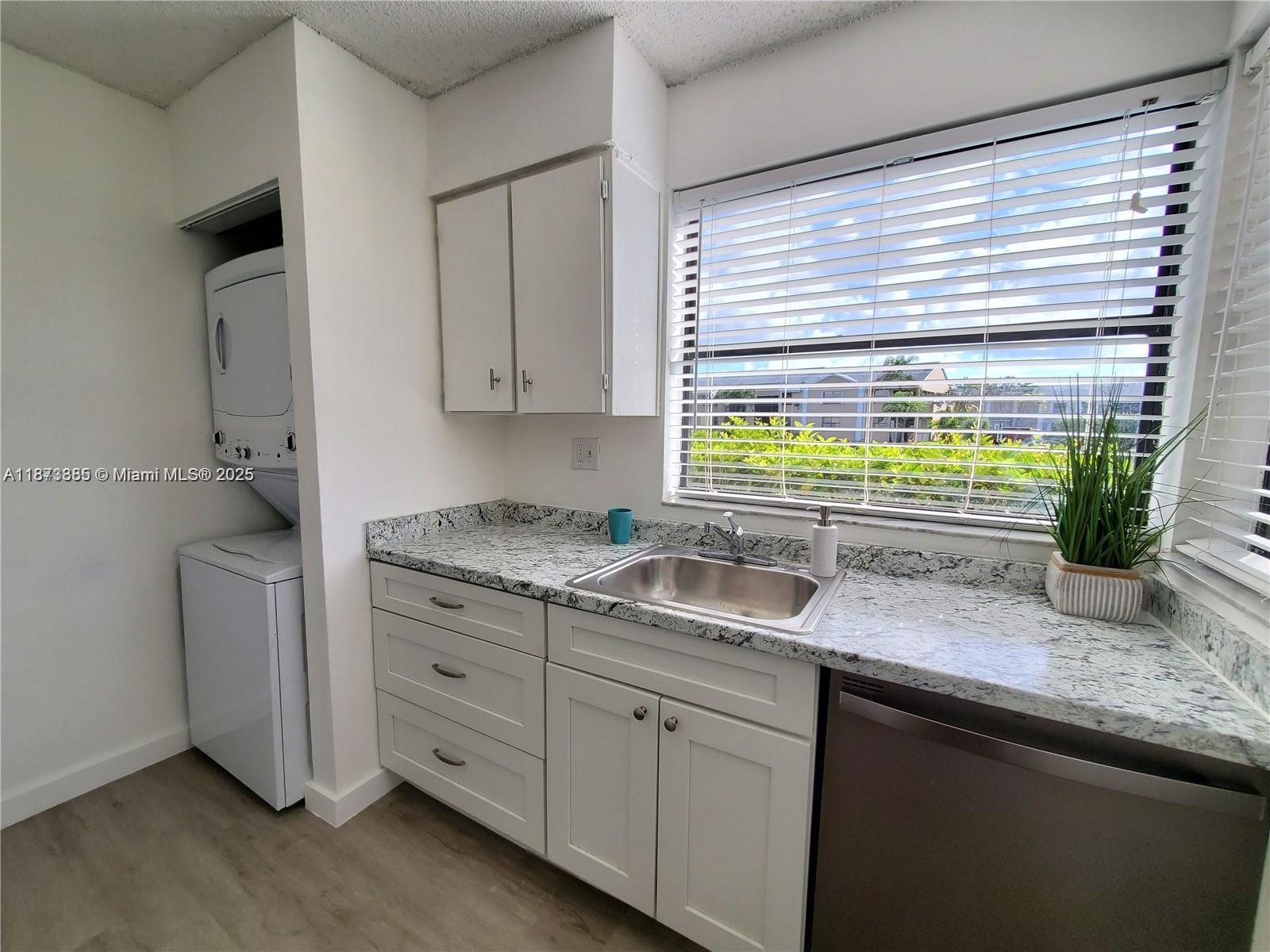 a kitchen with granite countertop a sink and a window