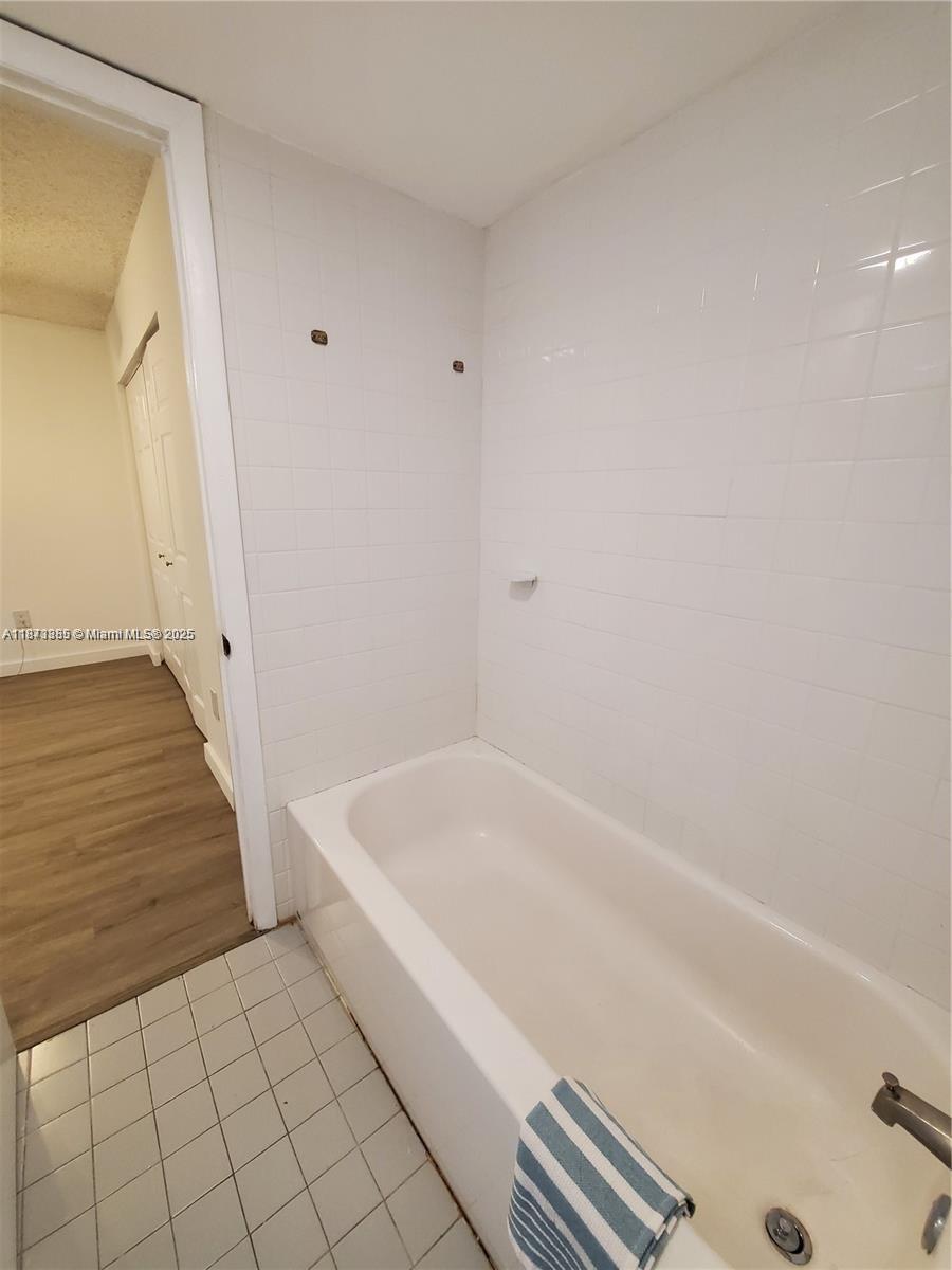 1017 Washington Circle, Unit F Homestead, FL 33034 - Photo 15 of 34 a bathroom with a bathtub and shower