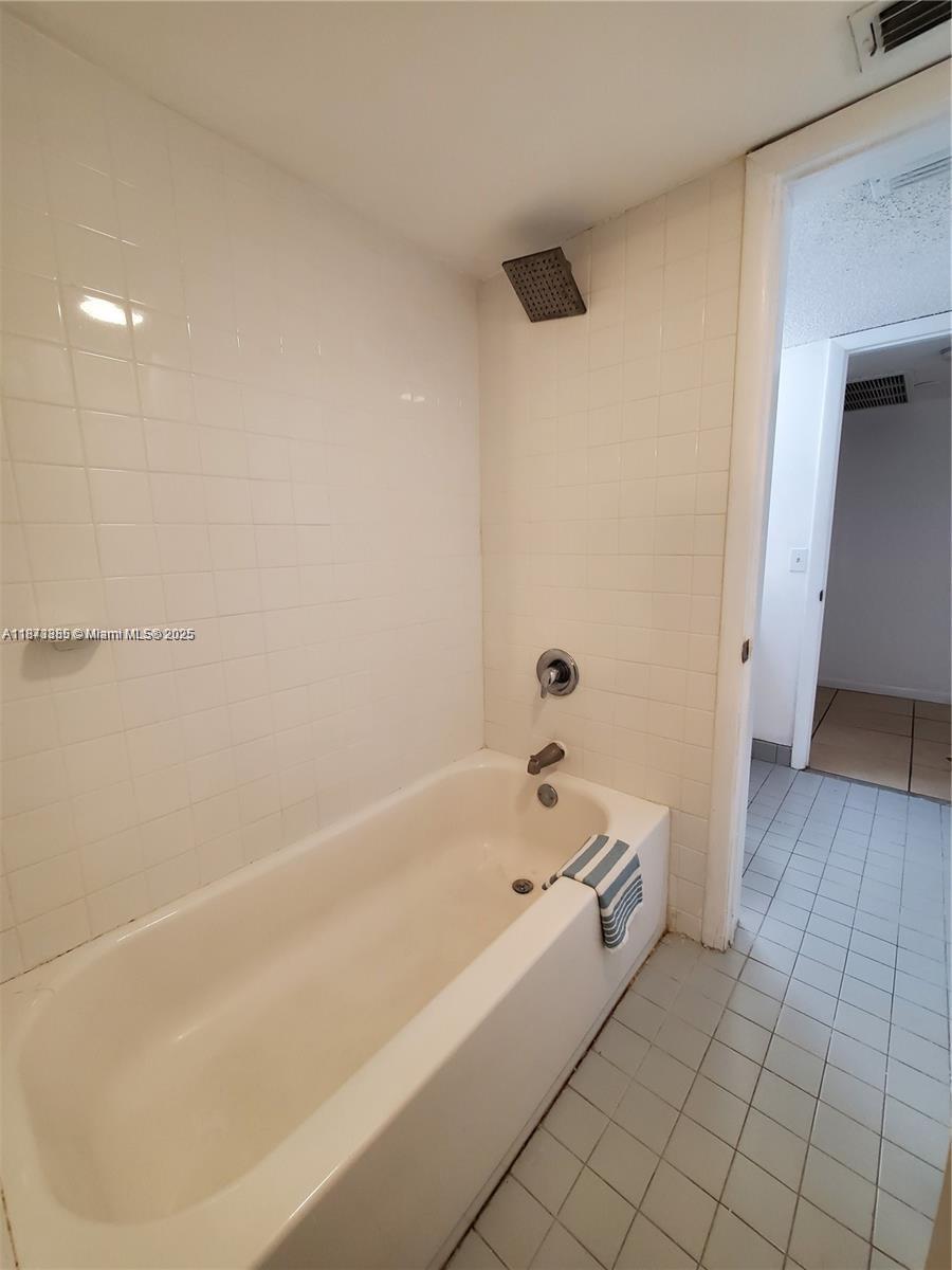 1017 Washington Circle, Unit F Homestead, FL 33034 - Photo 18 of 34 a spacious bathroom with a bathtub and a shower