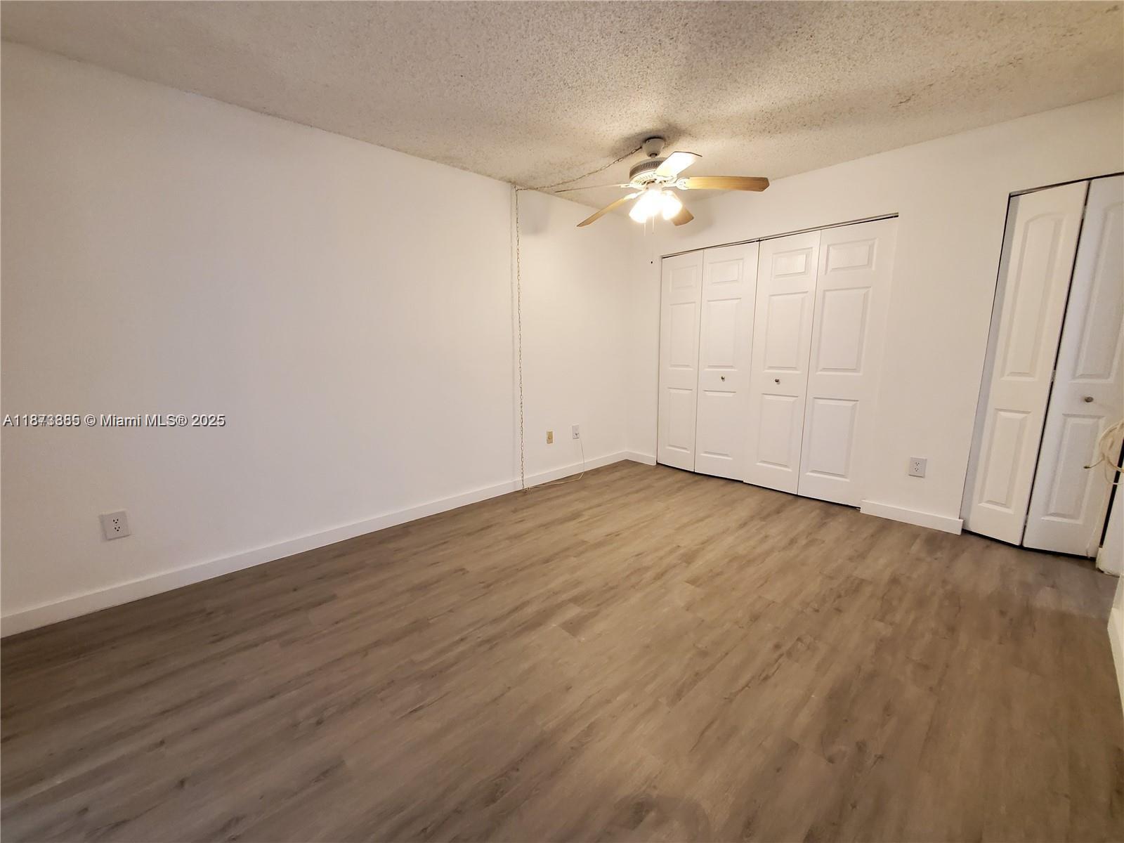 1017 Washington Circle, Unit F Homestead, FL 33034 - Photo 19 of 34 a view of an empty room with wooden floor
