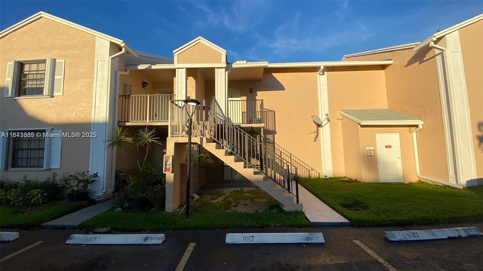 1017 Washington Circle, Unit F Homestead, FL 33034 - Photo 2 of 34 a view of a house with many windows and yard