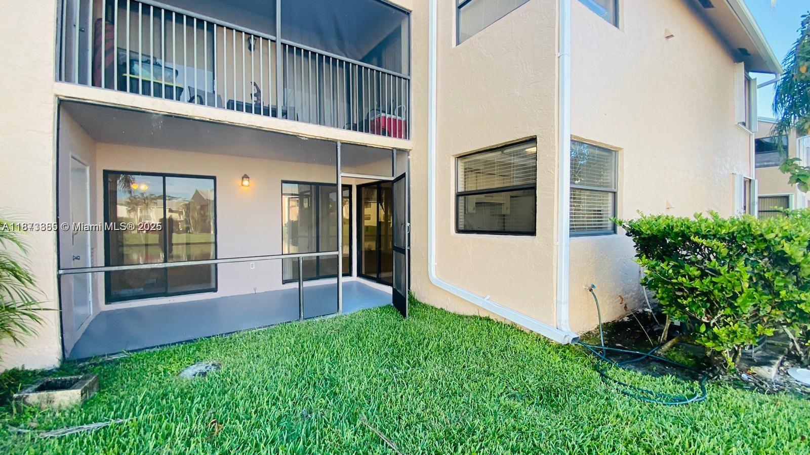 1017 Washington Circle, Unit F Homestead, FL 33034 - Photo 25 of 34 a view of house with backyard and glass windows