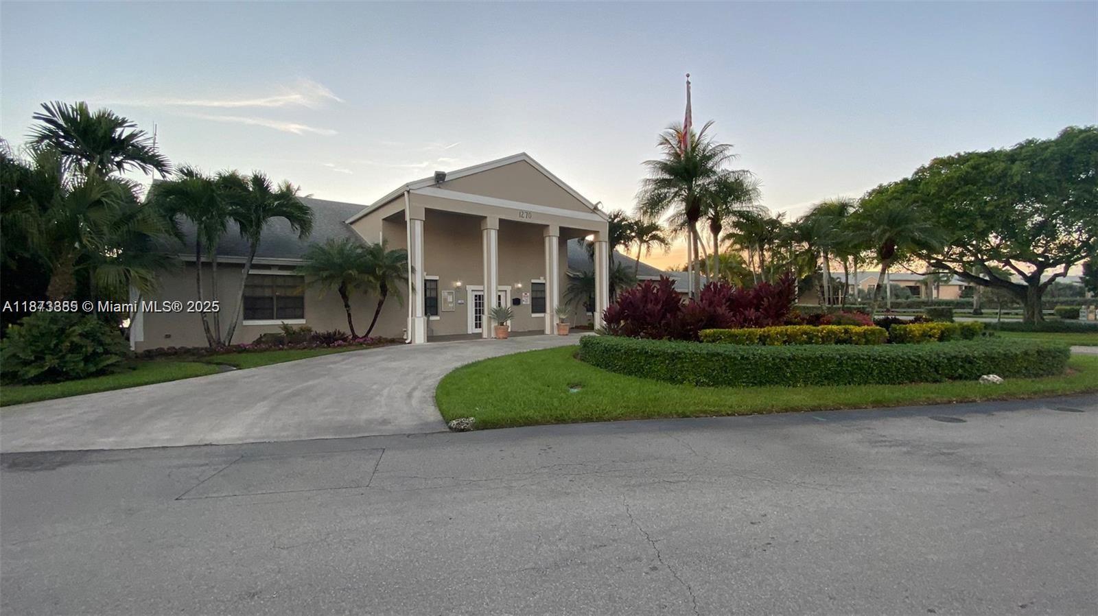 1017 Washington Circle, Unit F Homestead, FL 33034 - Photo 31 of 34 a front view of a house with a yard and garage
