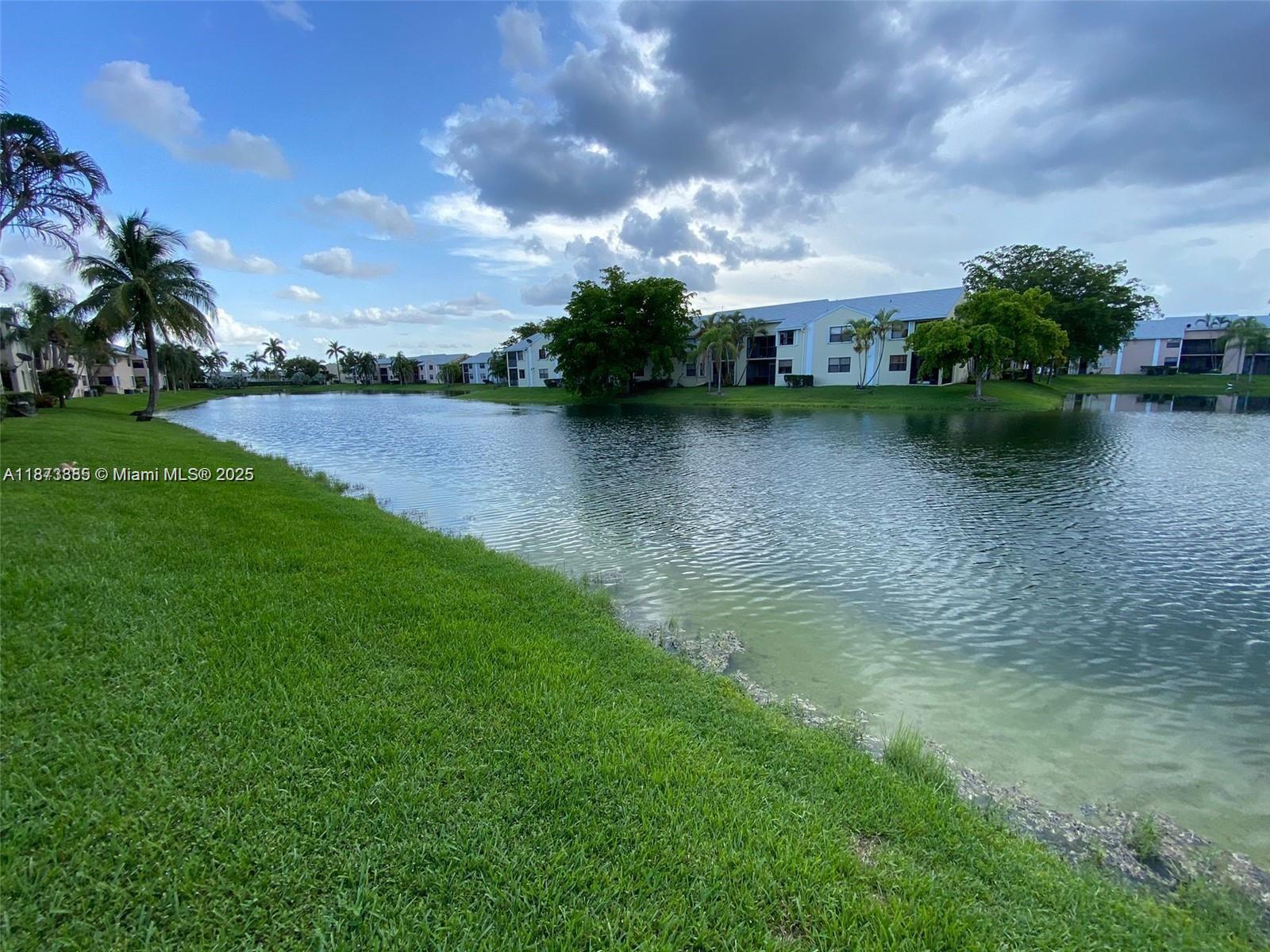 1017 Washington Circle, Unit F Homestead, FL 33034 - Photo 32 of 34 a view of a lake with houses in the back