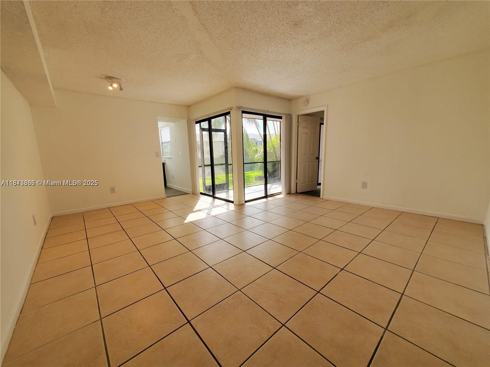 1017 Washington Circle, Unit F Homestead, FL 33034 - Photo 5 of 34 a view of an empty room and window