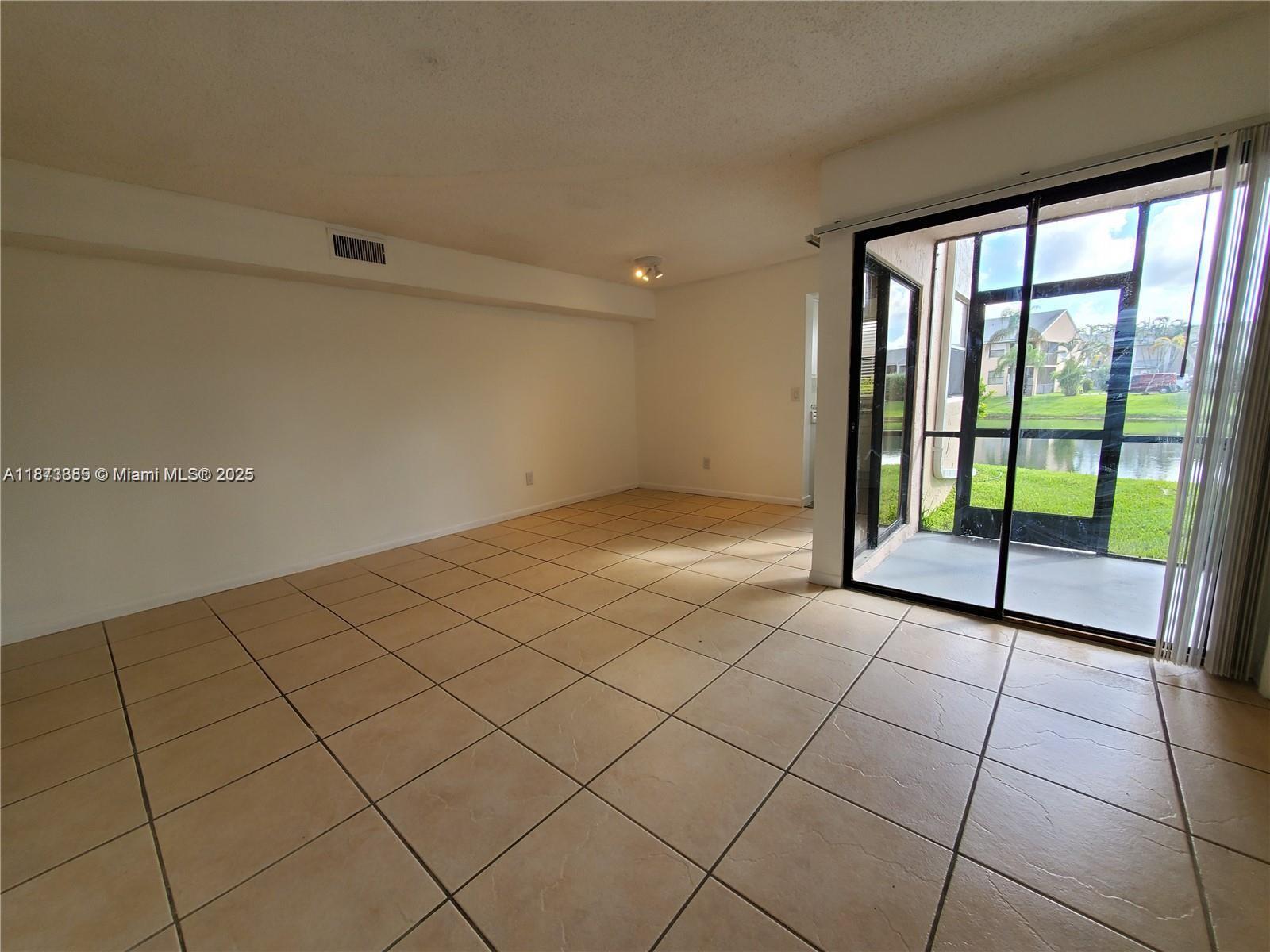1017 Washington Circle, Unit F Homestead, FL 33034 - Photo 7 of 34 a view of a livingroom with a large window