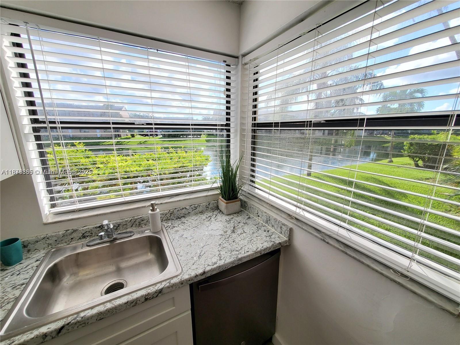 1017 Washington Circle, Unit F Homestead, FL 33034 - Photo 10 of 34 a bathroom with a granite countertop sink and a large window