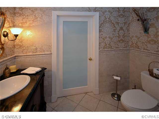 10741 Cherokee Road Midlothian, VA 23113 - Photo 23 of 23 a bathroom with a toilet a sink and mirror