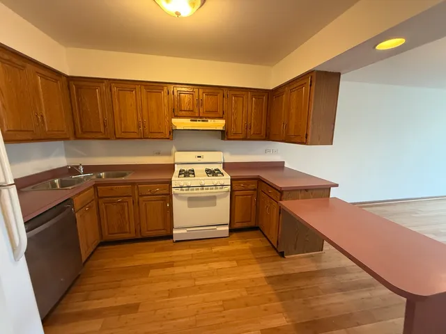 a kitchen with a stove top oven sink and cabinets