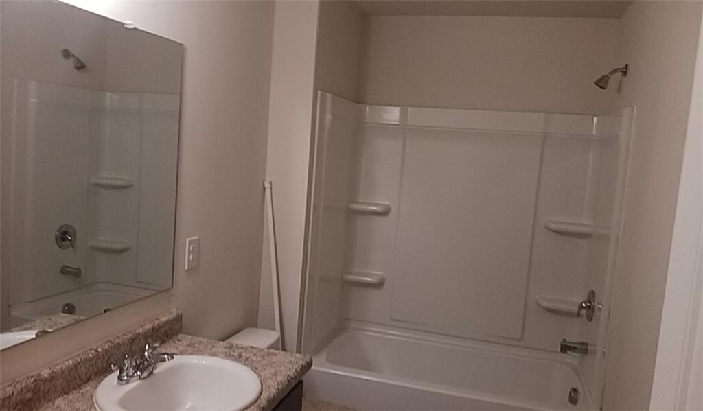 1033 Eldon Lane Fairburn, GA 30213 - Photo 17 of 21 a bathroom with a granite countertop sink toilet and shower