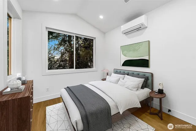 a bedroom with a bed and wooden floor