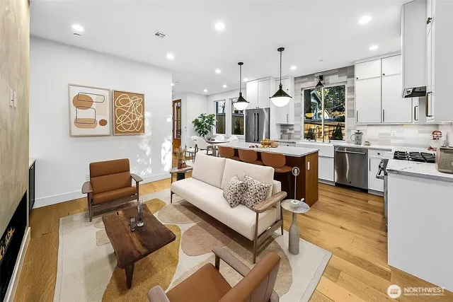 a living room with stainless steel appliances kitchen island granite countertop furniture and a view of kitchen