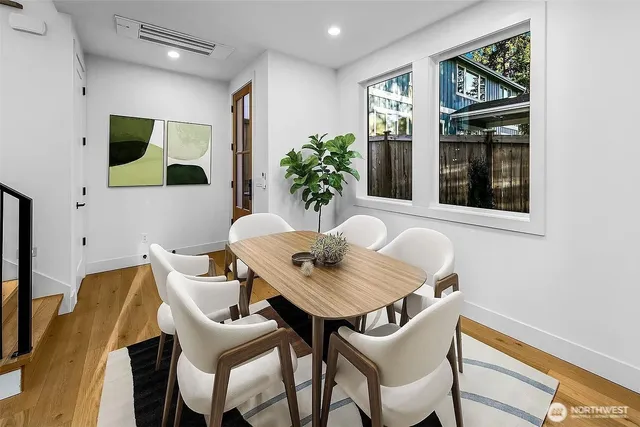 a view of a dining room with furniture window and wooden floor