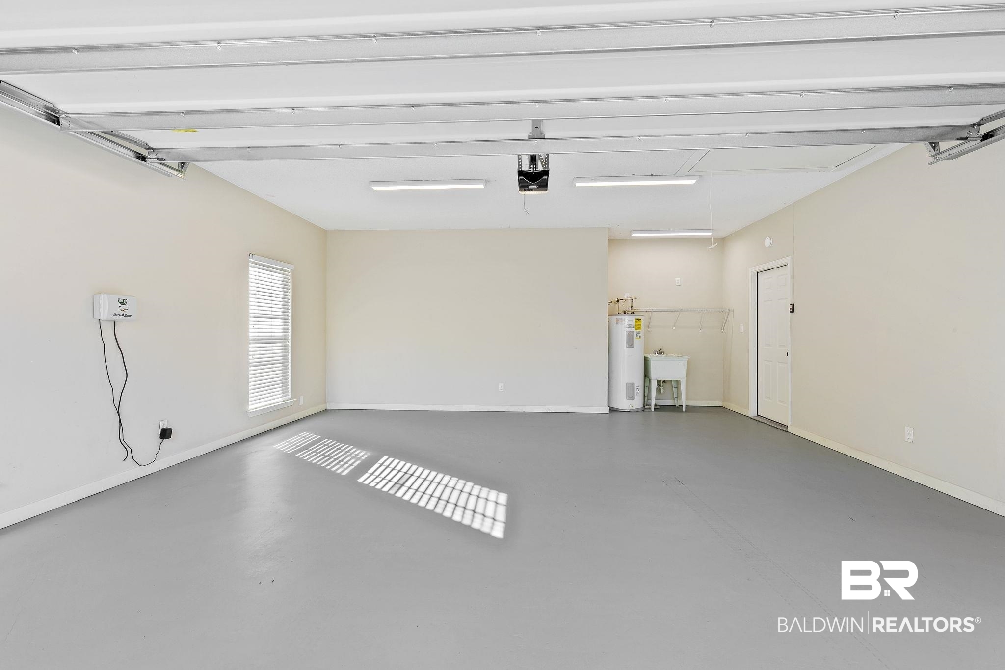 9631 Bay Meadows Avenue Fairhope, AL 36532 - Photo 30 of 49 Garage featuring sink and water heater