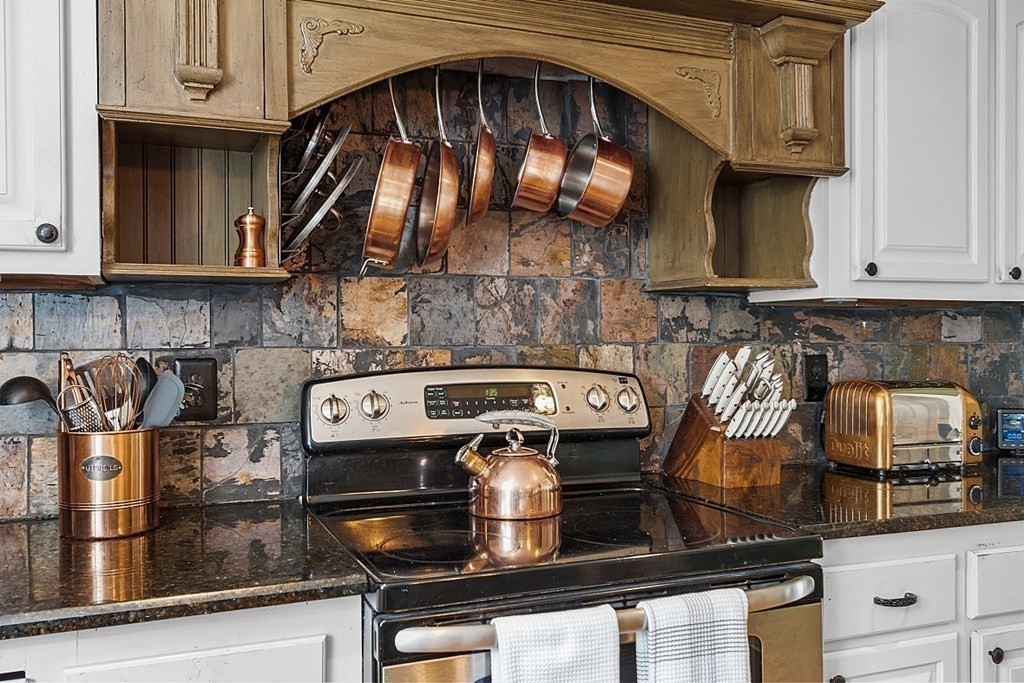 131 Lawrence Road Haverhill, MA 01835 - Photo 12 of 39 a kitchen with a stove and a microwave