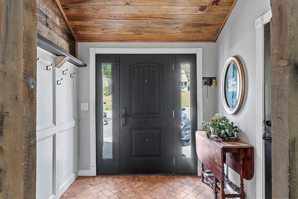 131 Lawrence Road Haverhill, MA 01835 - Photo 15 of 39 a view of a hallway with entryway wooden floor and a dining room