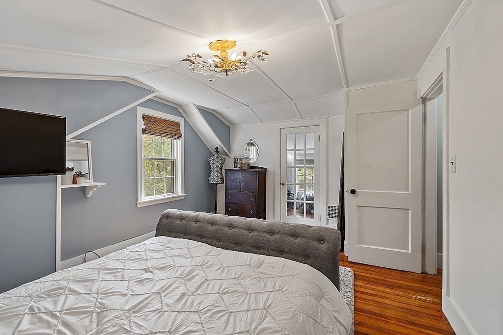 131 Lawrence Road Haverhill, MA 01835 - Photo 31 of 39 a bedroom with a bed and a chandelier