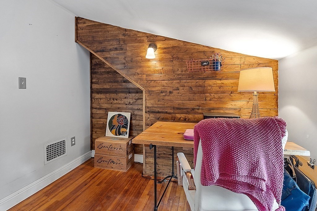 131 Lawrence Road Haverhill, MA 01835 - Photo 37 of 39 a balcony with chairs and wooden floor