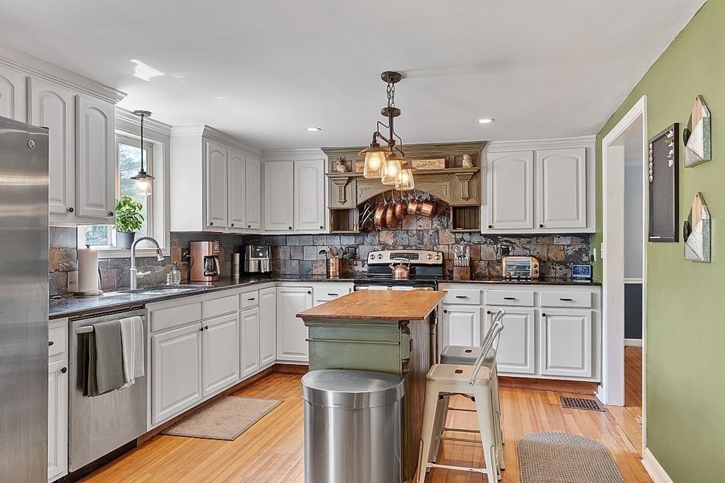 131 Lawrence Road Haverhill, MA 01835 - Photo 9 of 39 a kitchen with stainless steel appliances granite countertop a sink stove and refrigerator