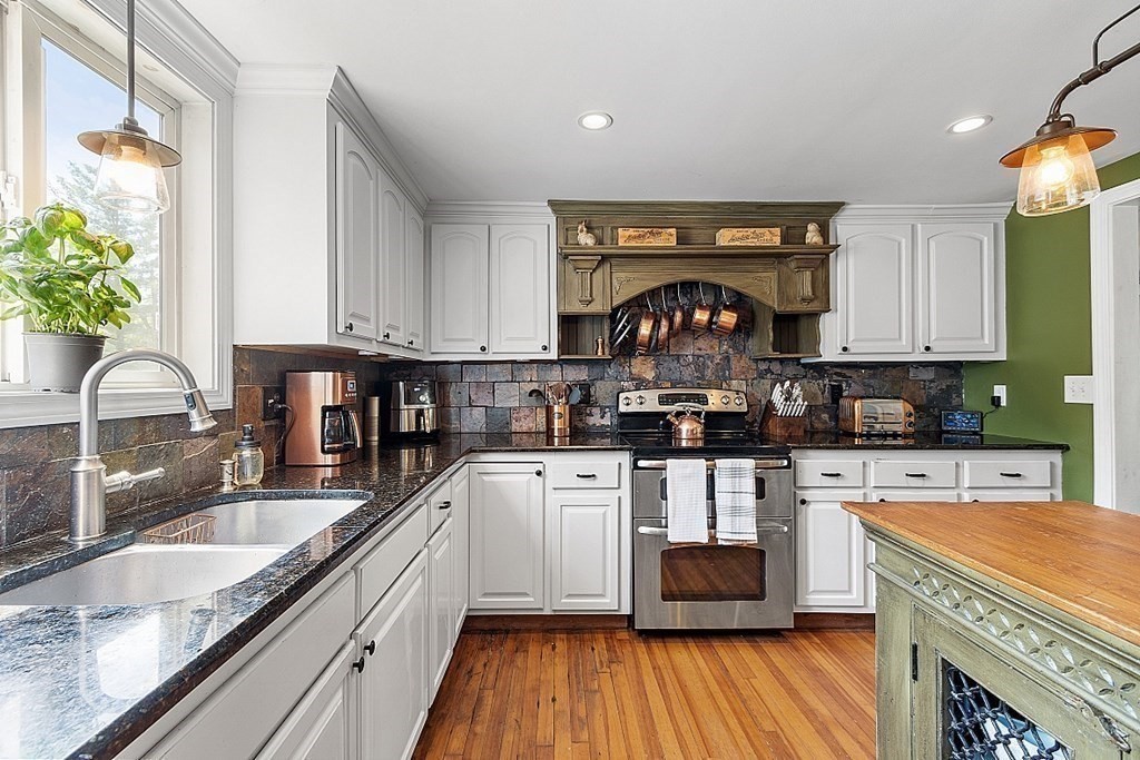 131 Lawrence Road Haverhill, MA 01835 - Photo 10 of 39 a kitchen with stainless steel appliances granite countertop a stove a sink and a granite counter tops with white cabinets