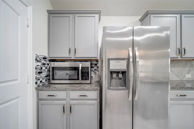a kitchen with cabinets and stainless steel appliances