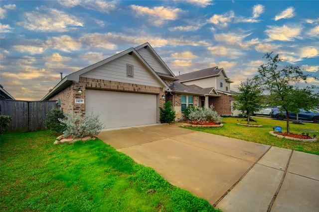 a view of a house with pool and a yard