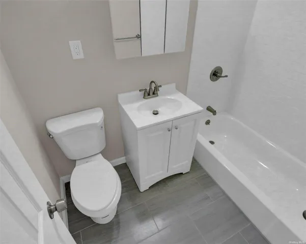 a bathroom with a sink toilet and bathtub