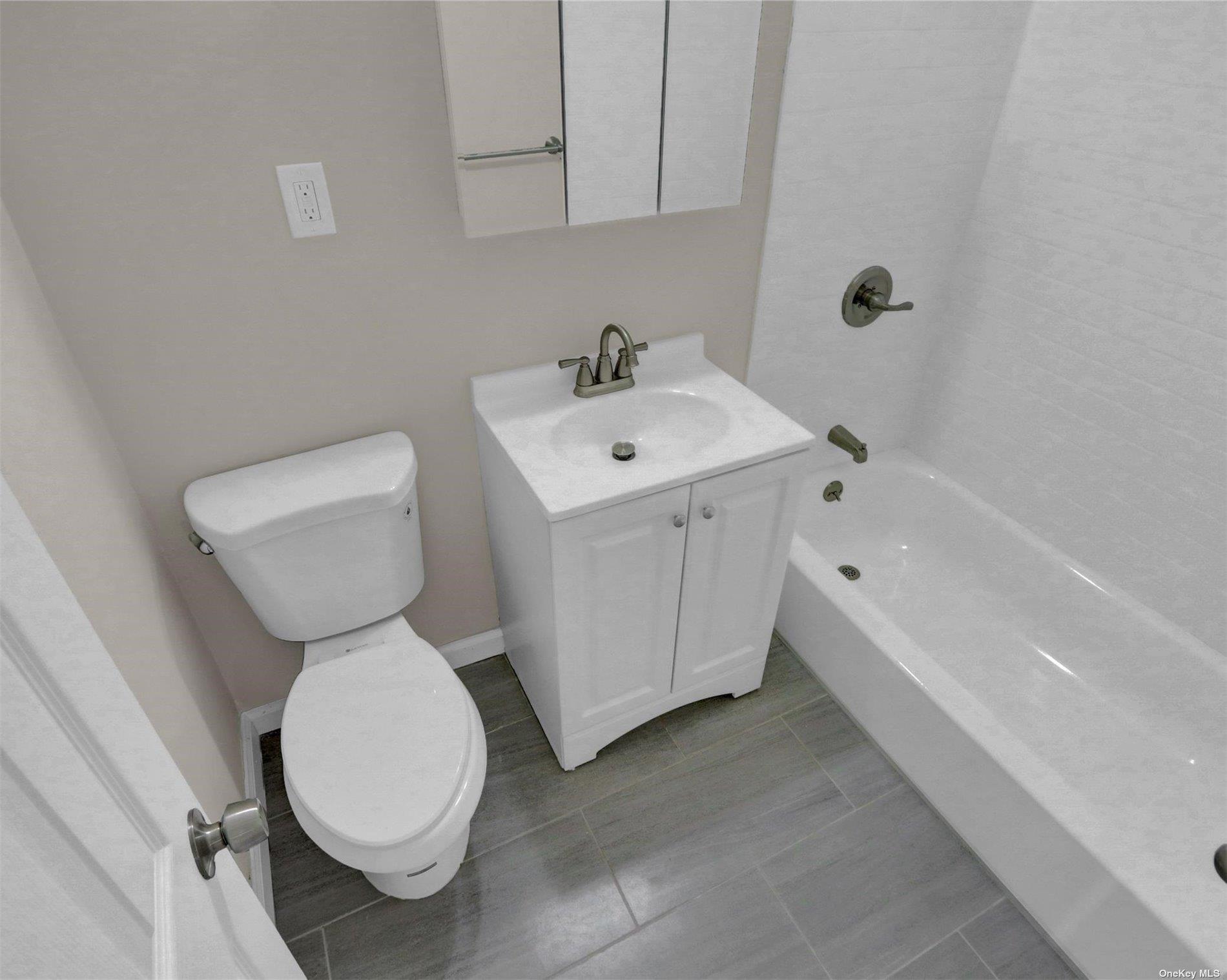 151-31 88th Street, Unit 6H Queens, NY 11414 - Photo 20 of 20 a bathroom with a sink toilet and bathtub