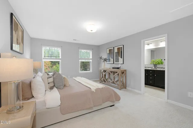 a bedroom with a bed and a large mirror