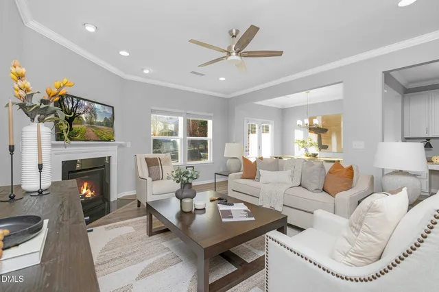 a living room with furniture a fireplace and a flat screen tv