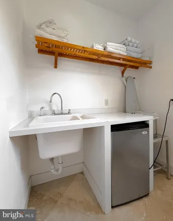 a kitchen with stainless steel appliances a refrigerator a sink a stove and cabinets