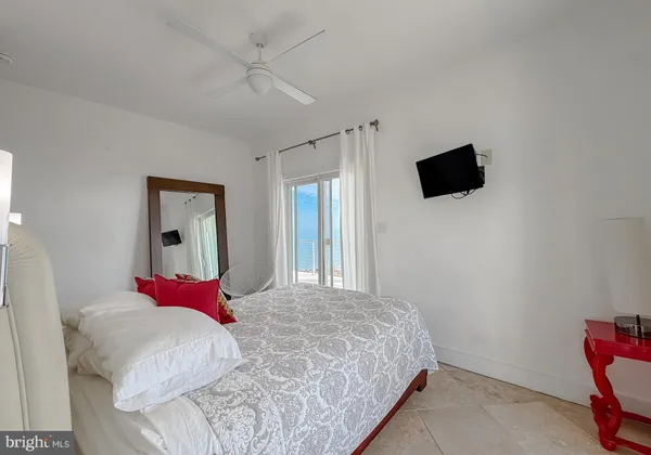 a bedroom with a bed wooden floor and a fireplace