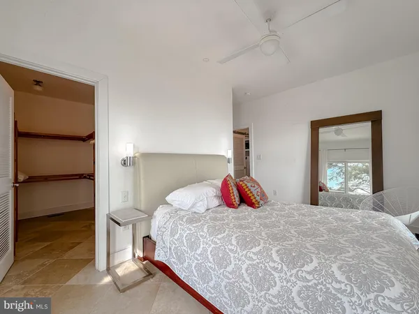 a bedroom with a large bed and a flat tv screen