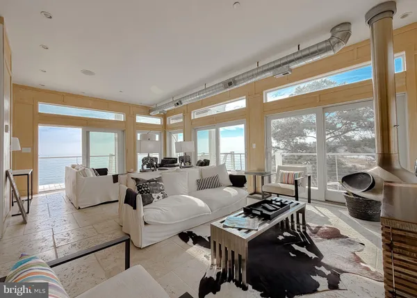 a living room with furniture and large windows