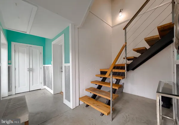 a living room with a couch and two windows