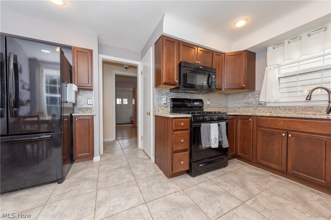 3586 Ingleside Road Beachwood, OH 44122 - Photo 6 of 22 The remodeled Kitchen with granite counters, glass tile backsplash and ceramic tile floor