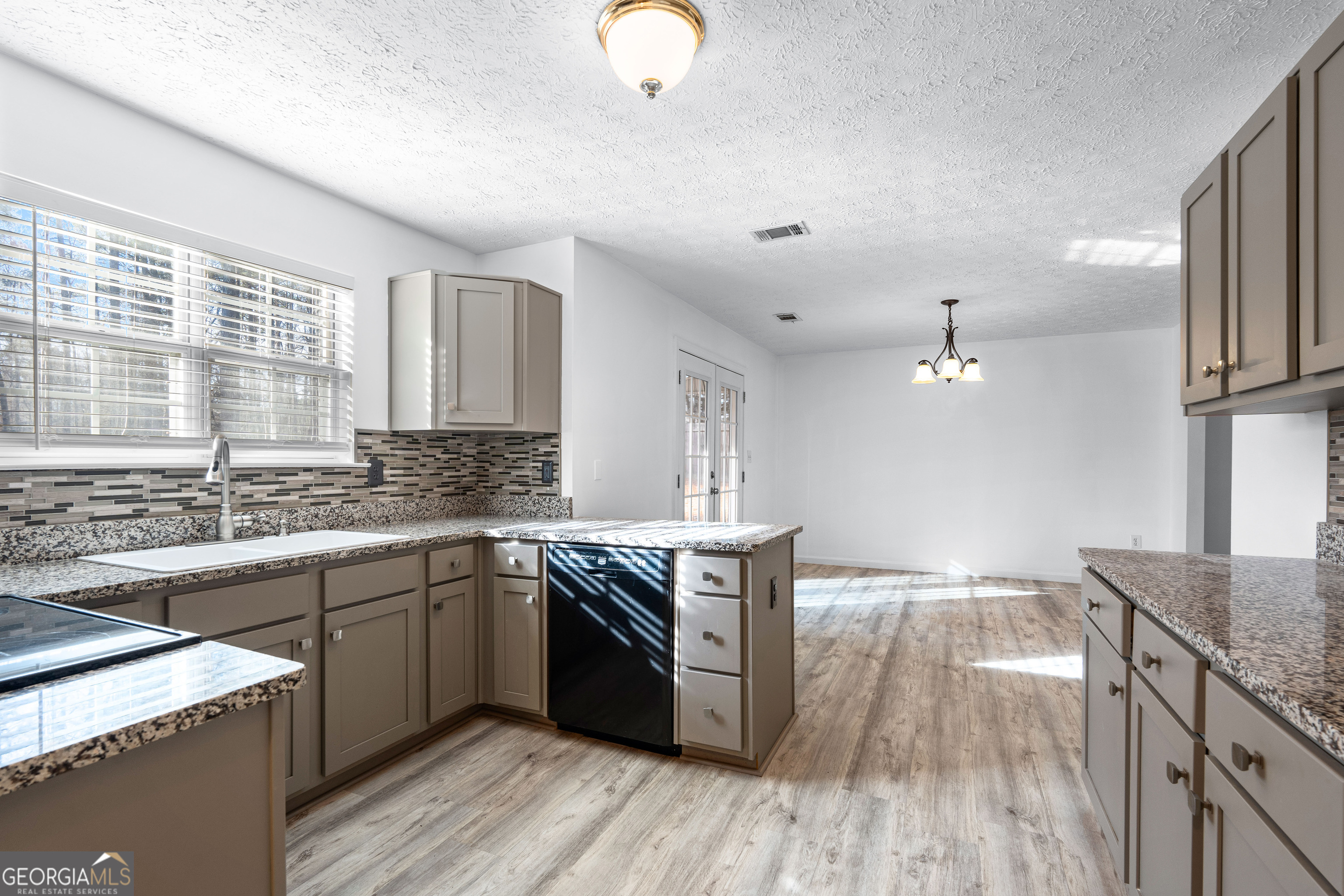 19 Rayner Drive Newnan, GA 30265 - Photo 14 of 53 a kitchen with stainless steel appliances granite countertop a stove and a sink