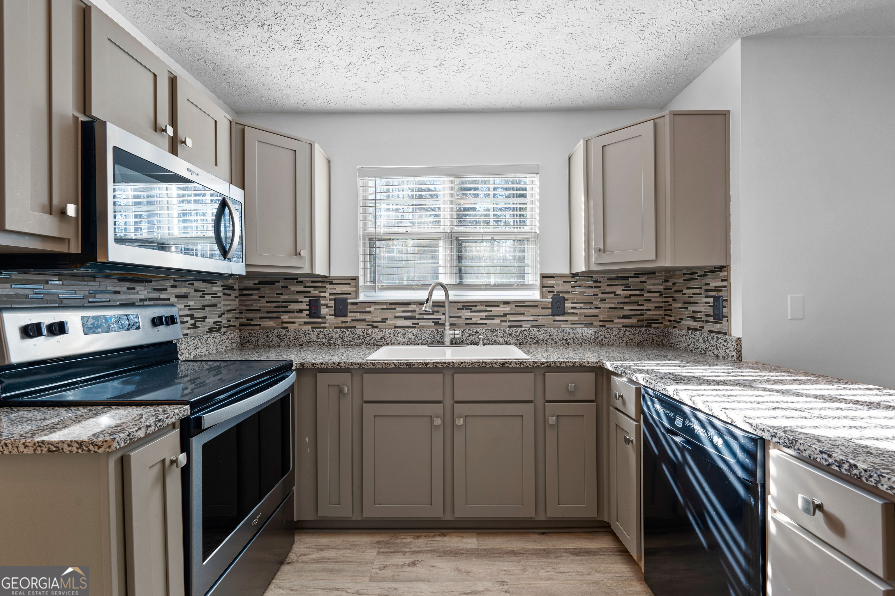 19 Rayner Drive Newnan, GA 30265 - Photo 15 of 53 a kitchen with a sink stove top oven and cabinets