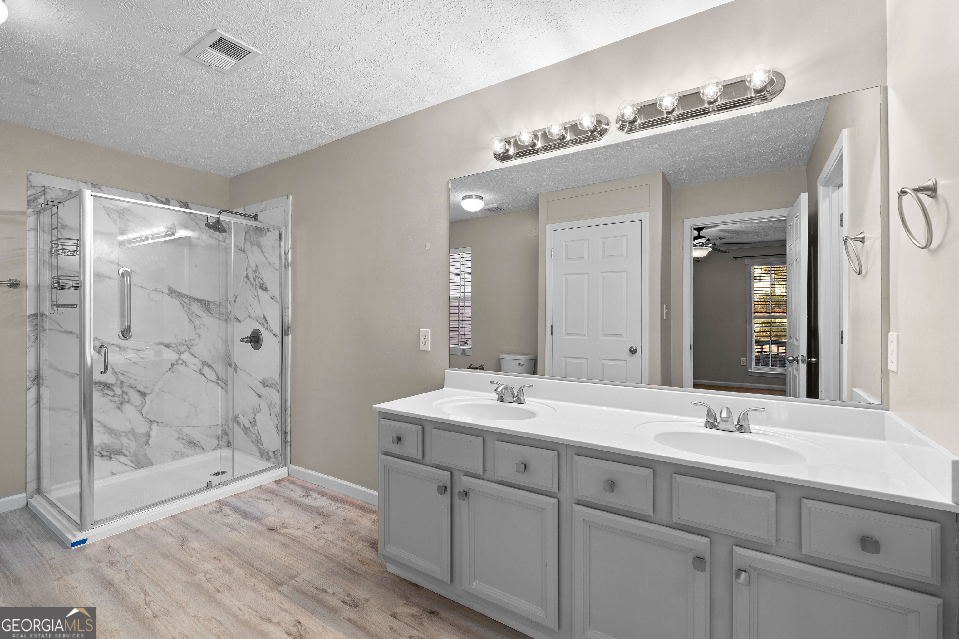 19 Rayner Drive Newnan, GA 30265 - Photo 20 of 53 a bathroom with a shower sink and mirror