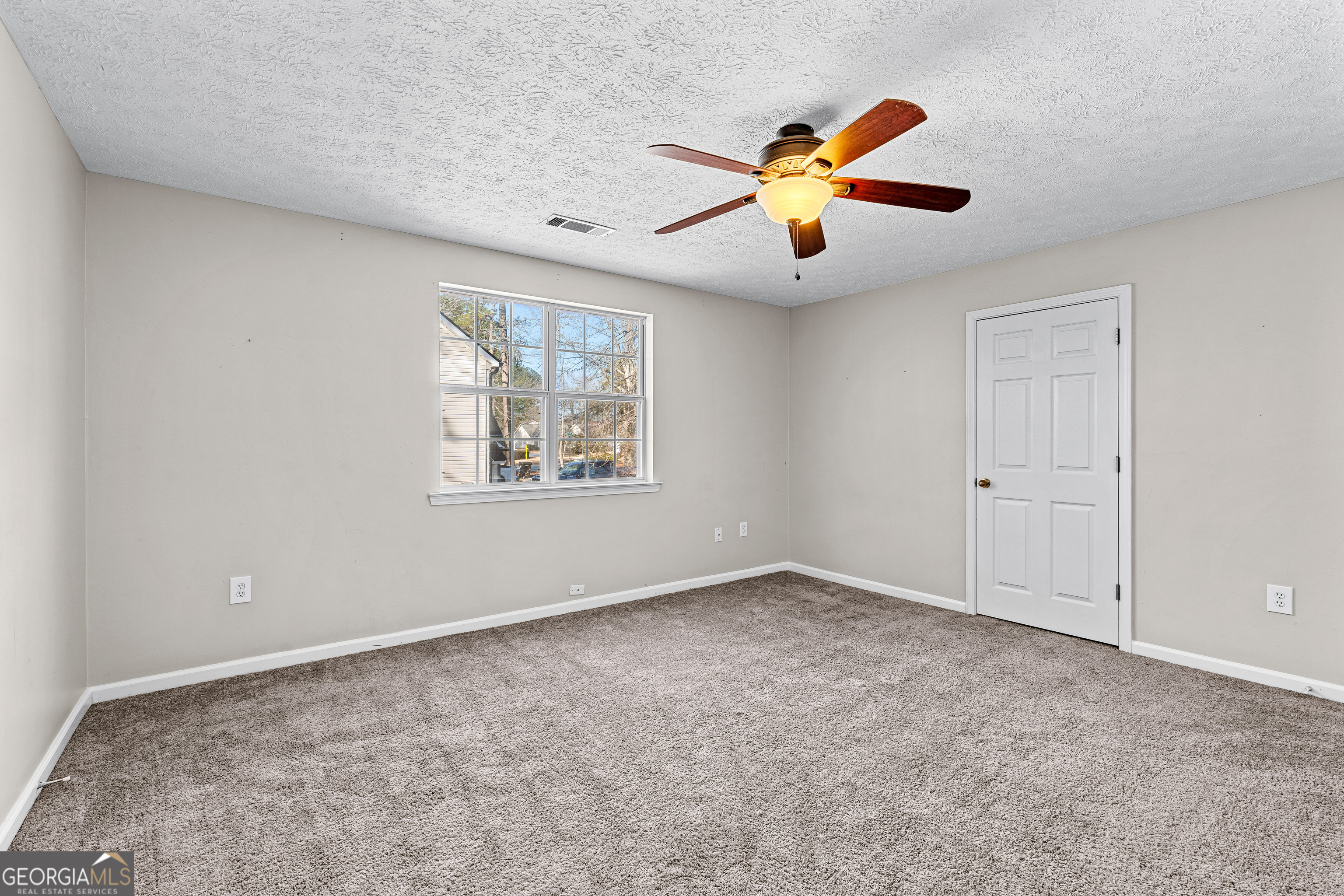 19 Rayner Drive Newnan, GA 30265 - Photo 27 of 53 an empty room with ceiling fan and window