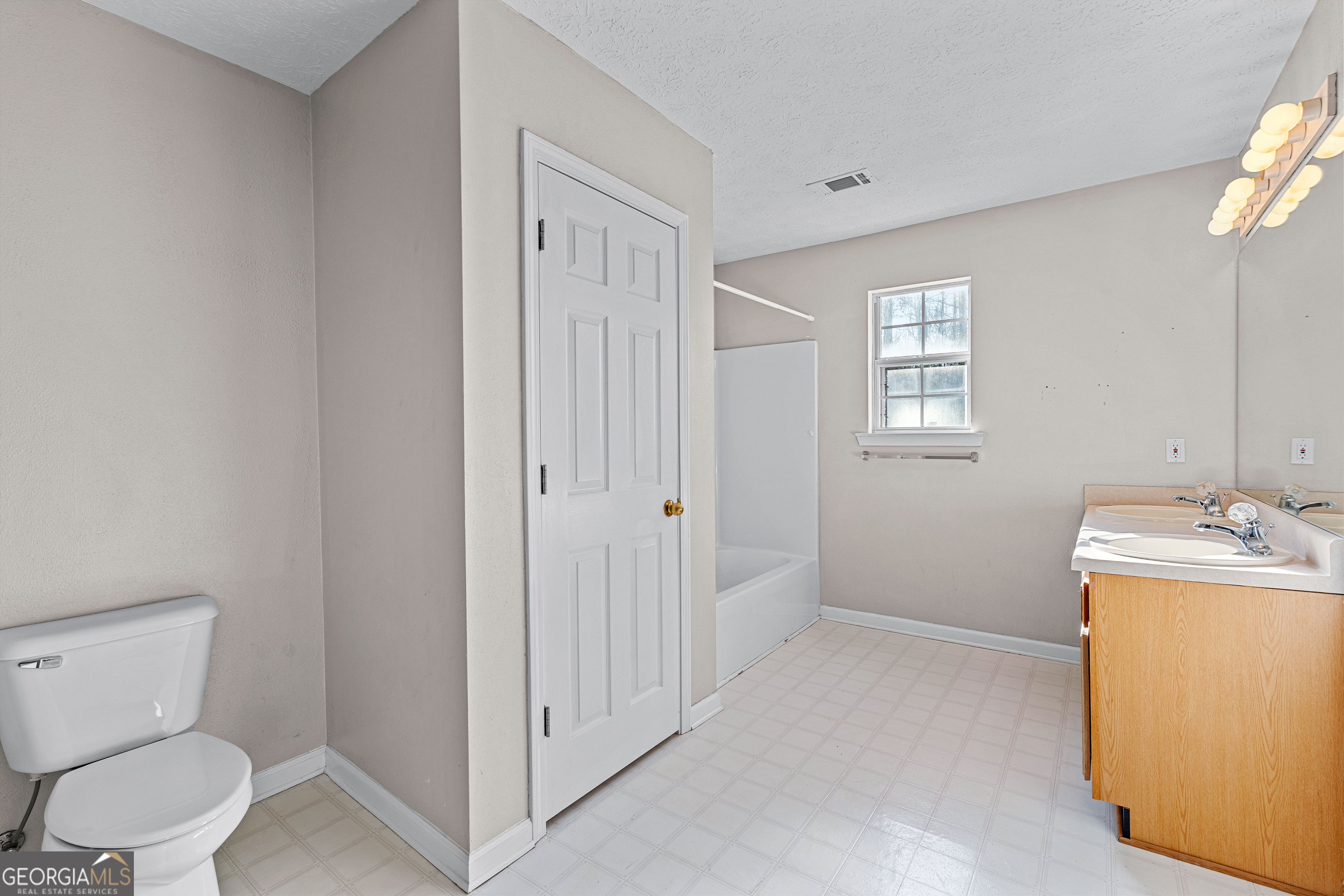 19 Rayner Drive Newnan, GA 30265 - Photo 32 of 53 a bathroom with a toilet sink and mirror