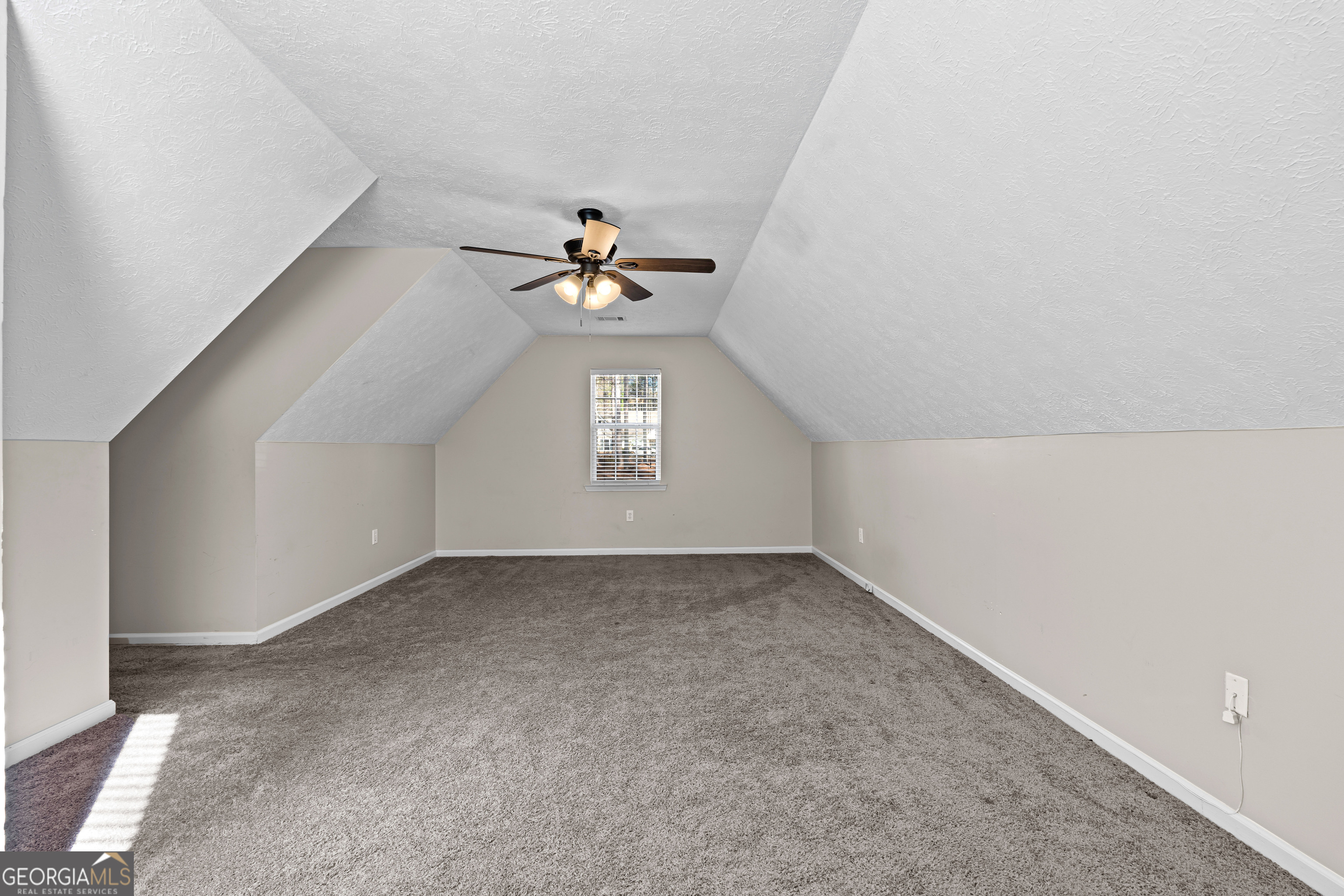 19 Rayner Drive Newnan, GA 30265 - Photo 39 of 53 an empty room with a chandelier fan and windows
