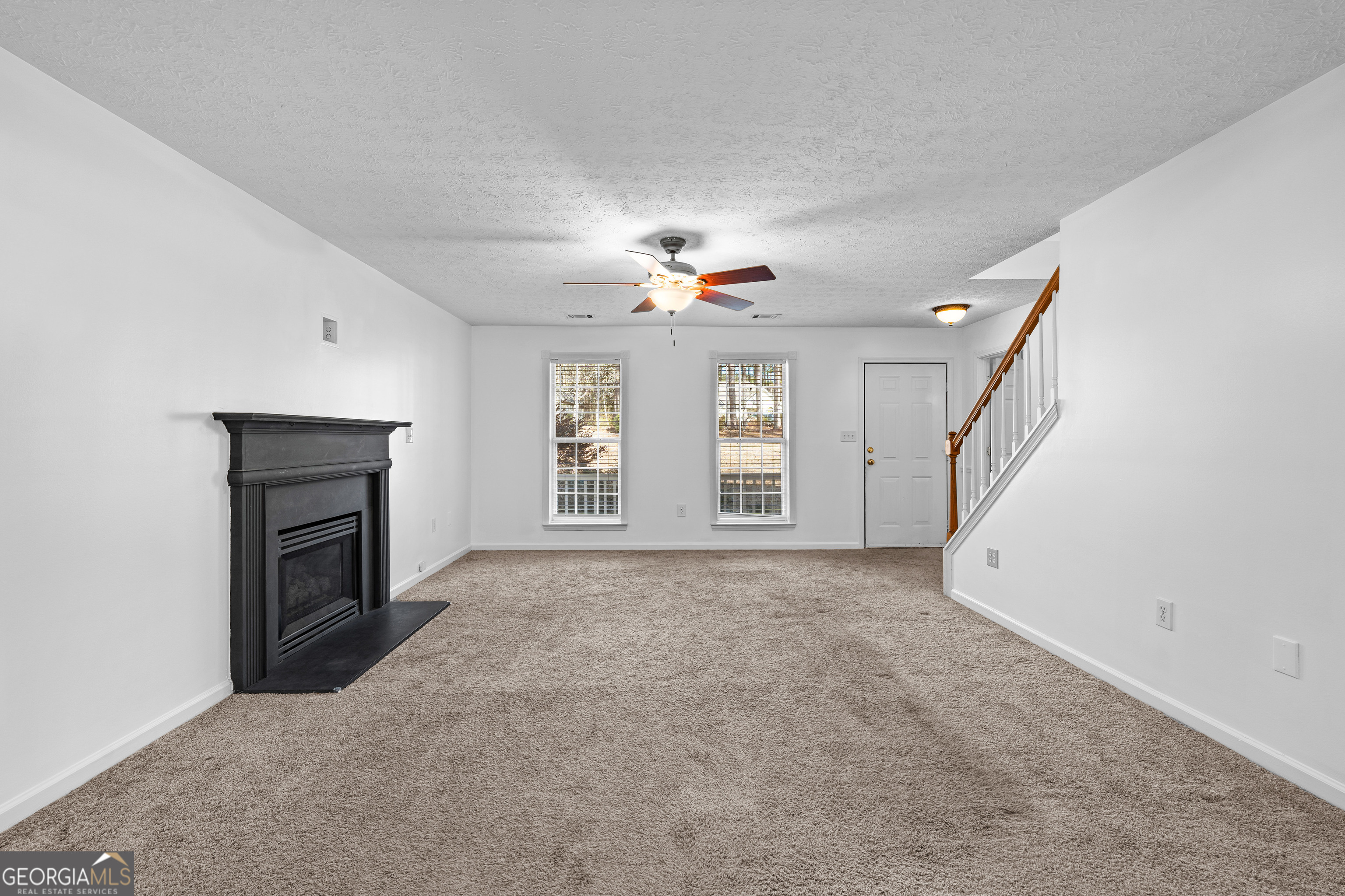 19 Rayner Drive Newnan, GA 30265 - Photo 8 of 53 a view of an empty room with a fireplace and a window
