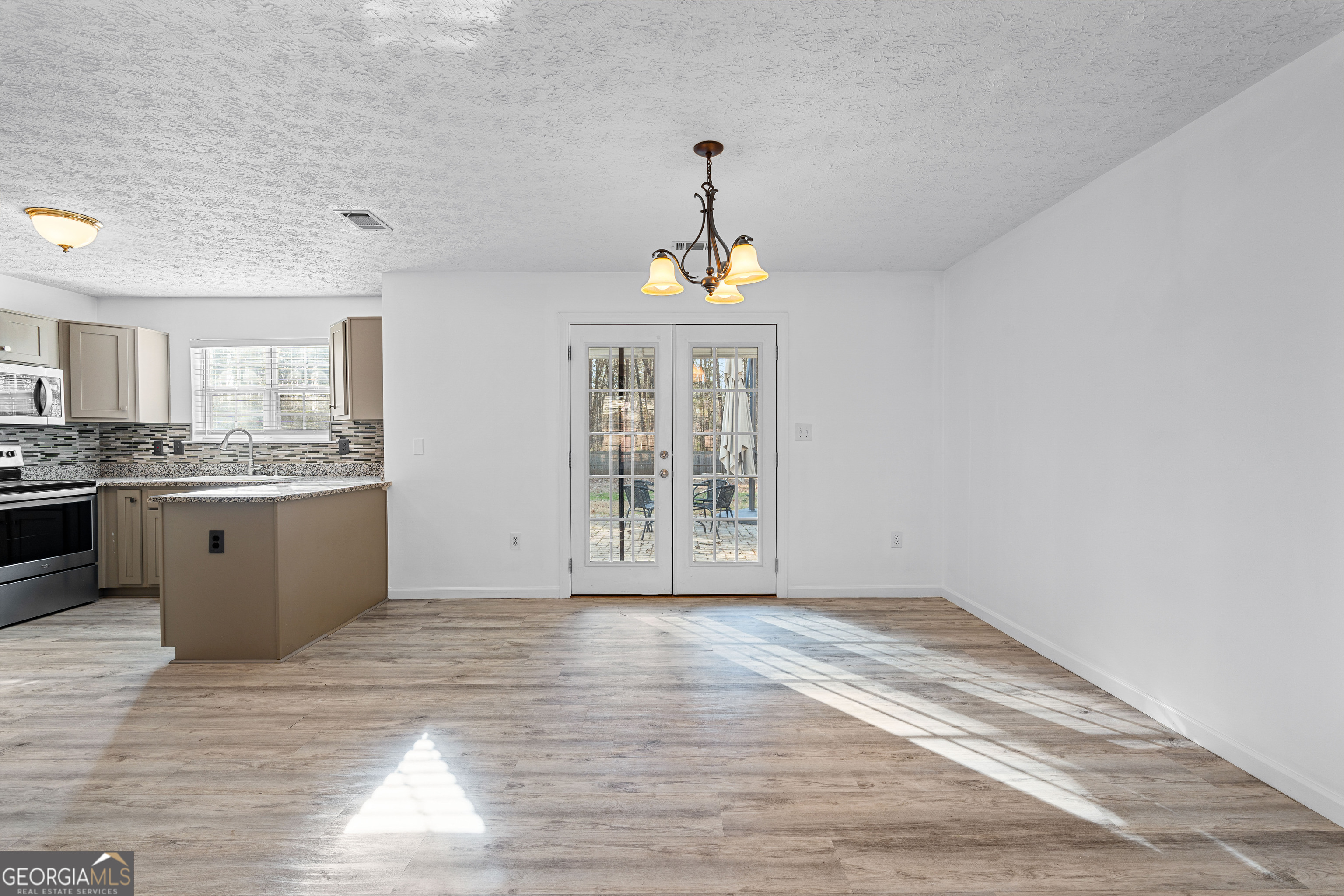 19 Rayner Drive Newnan, GA 30265 - Photo 10 of 53 a view of an empty room with window and wooden floor