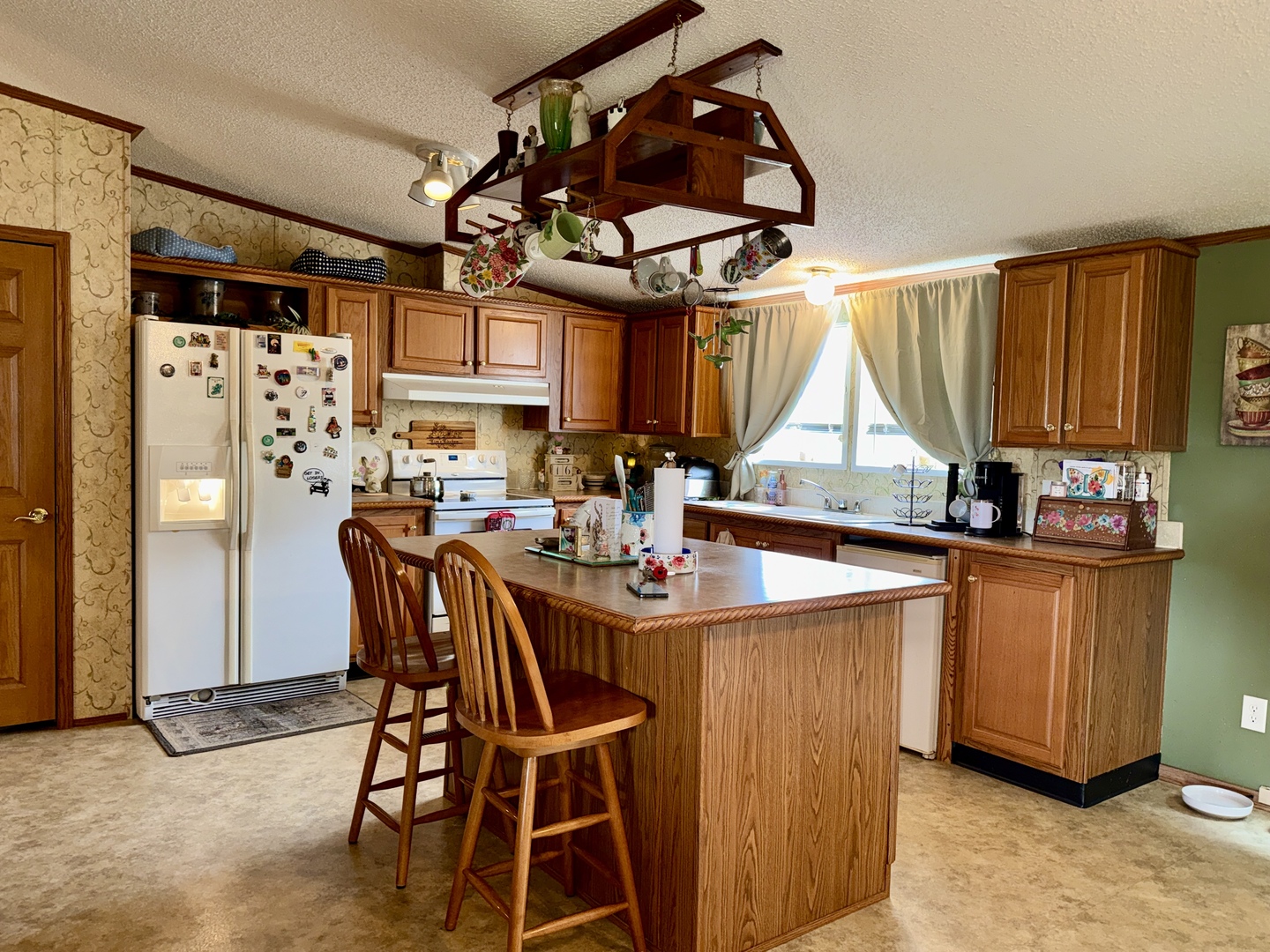 2025 Central Hill Road Grantsburg, IL 62943 - Photo 8 of 31 a kitchen with stainless steel appliances a table chairs and a refrigerator