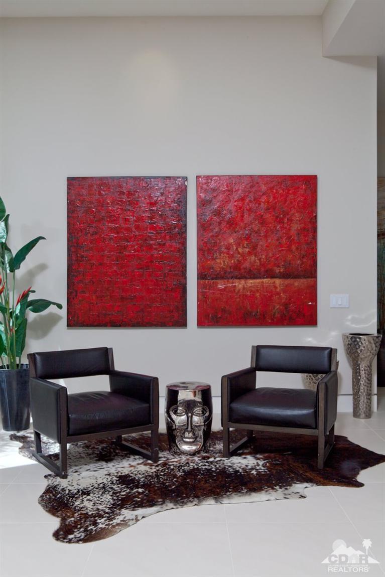 1 Mirada Circle Rancho Mirage, CA 92270 - Photo 16 of 29 a living room with furniture a flat screen tv and wall paintings