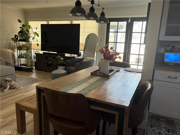 a dining room with a table chairs and a flat screen tv