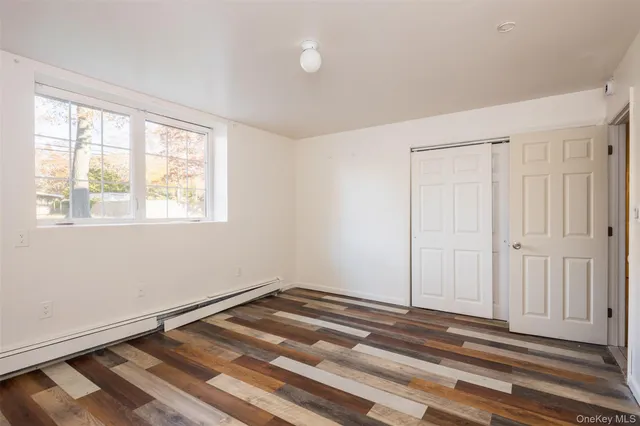 a view of a room with wooden floor and window