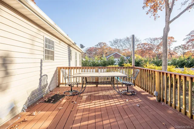 a view of balcony with wooden floor and outdoor seating