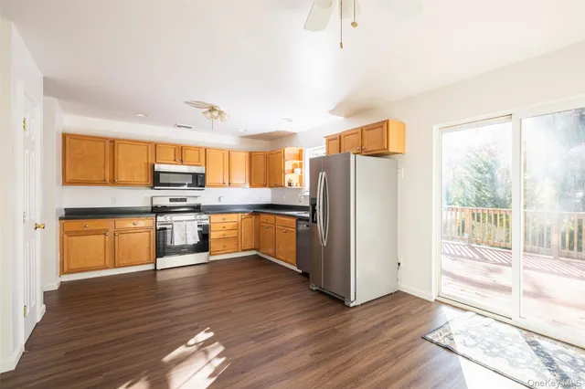 a kitchen with stainless steel appliances a refrigerator and wooden floor